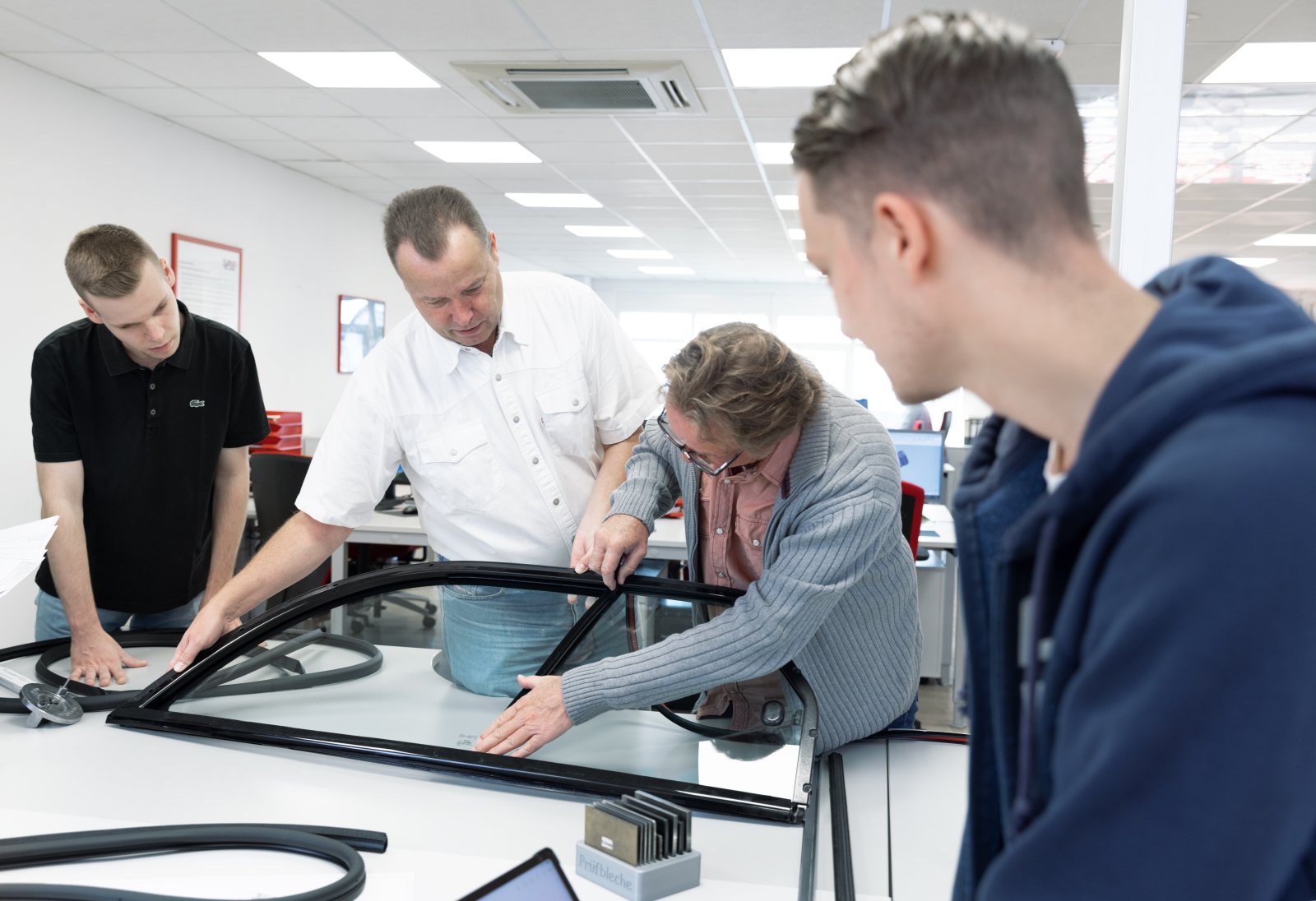 Several employees are testing a profile on a window